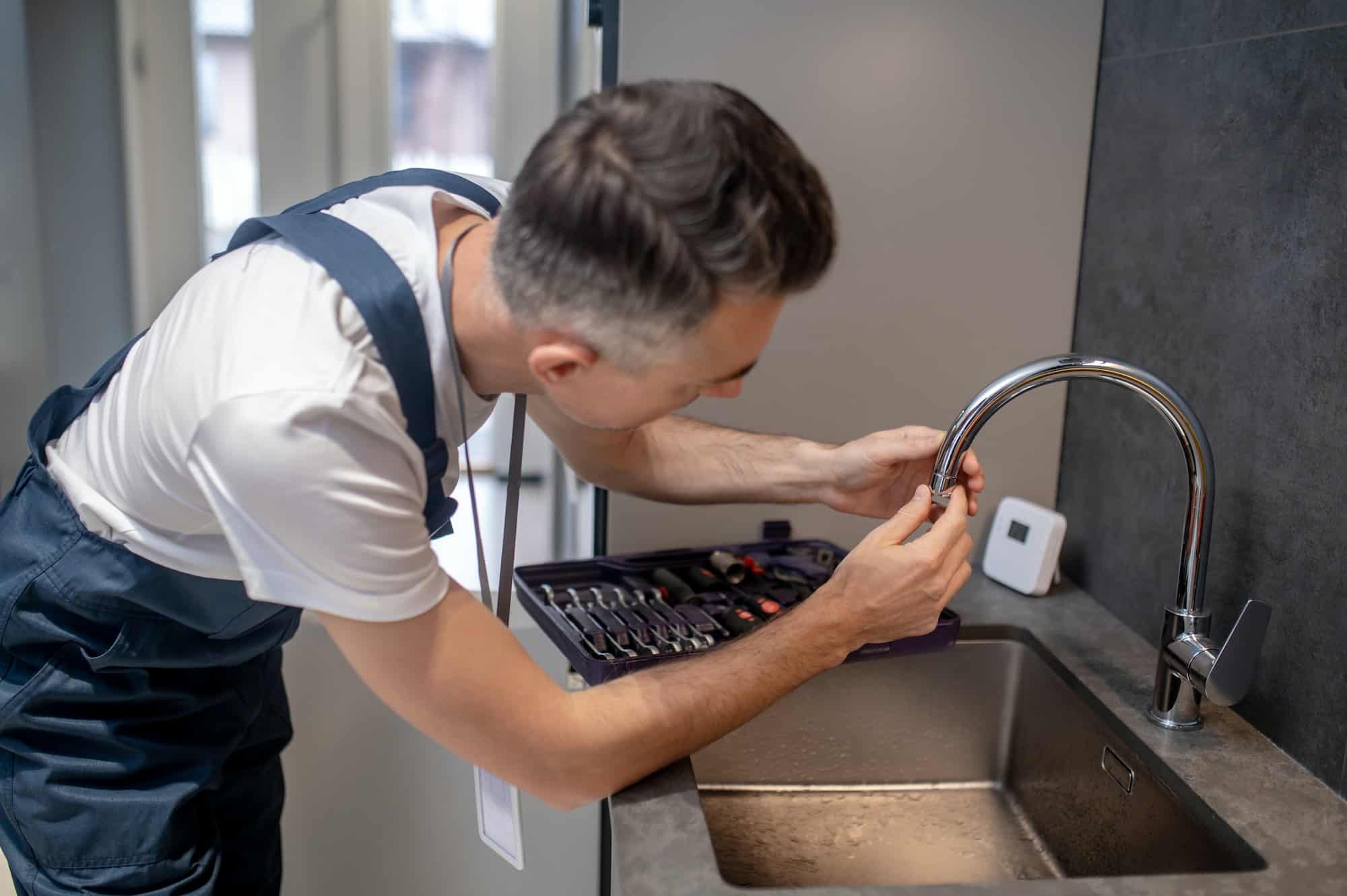 man-spinning-faucet-aerator-on-spout-pipe.jpg man-spinning-faucet-aerator-on-spout-pipe.jpg